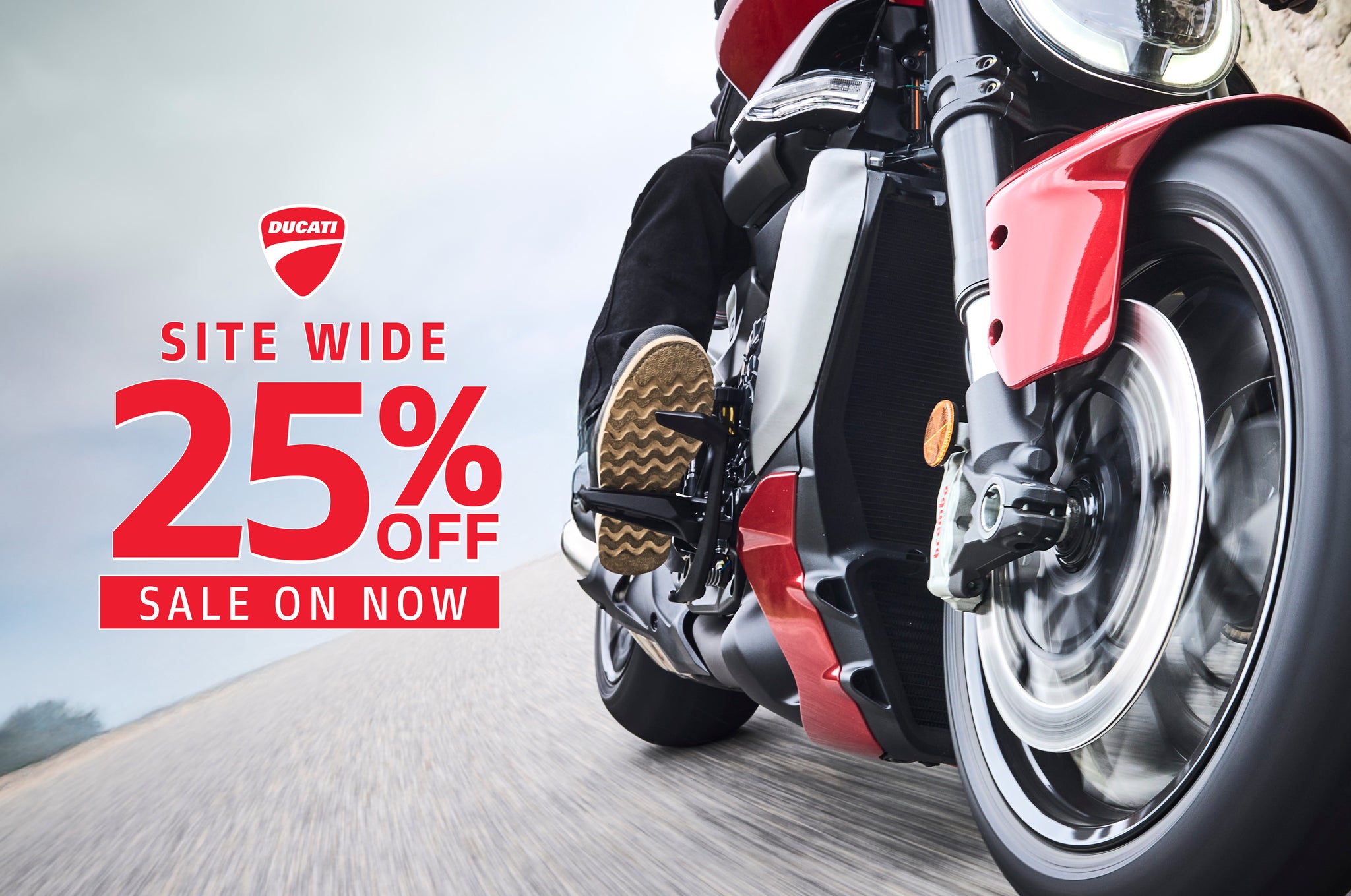 Red motorcycle on a road with a promotional banner for a 25% site-wide discount.